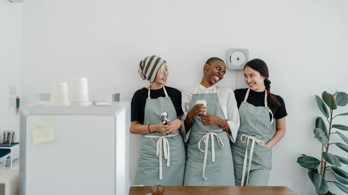 group of cafe employee standing together chatting