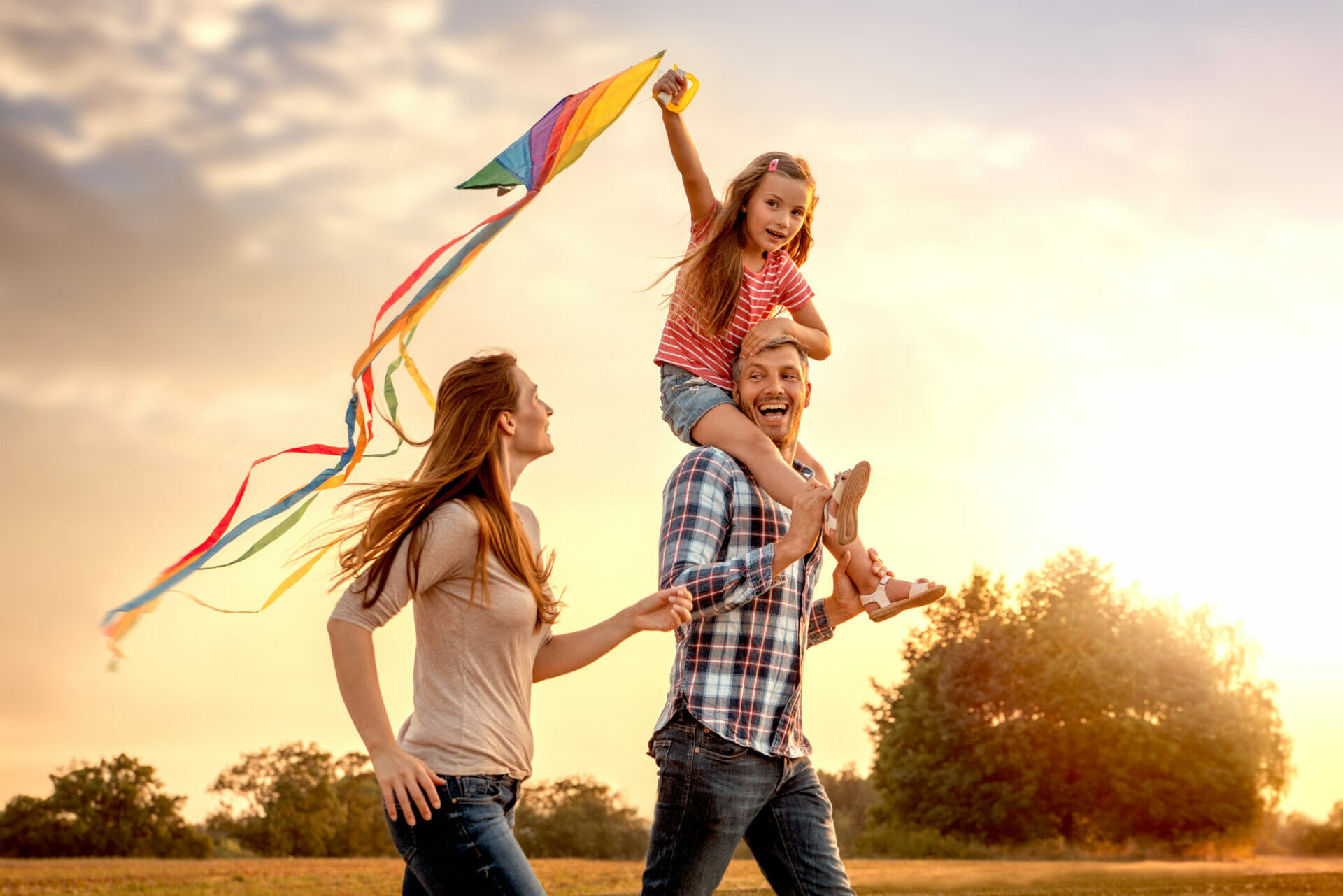 family flying a kite outdoor happily closeup shot 2