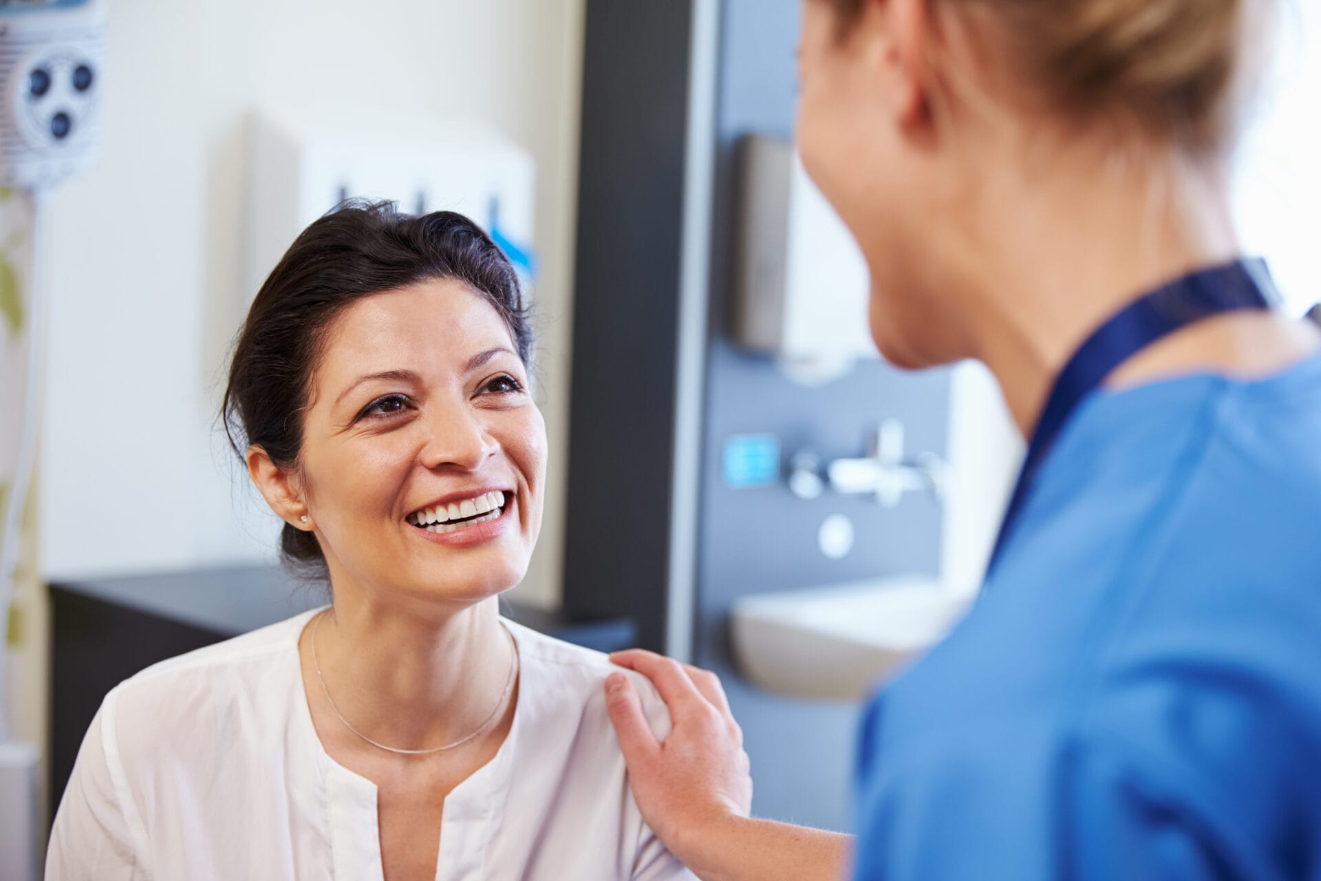 smiling woman consulting female doctor