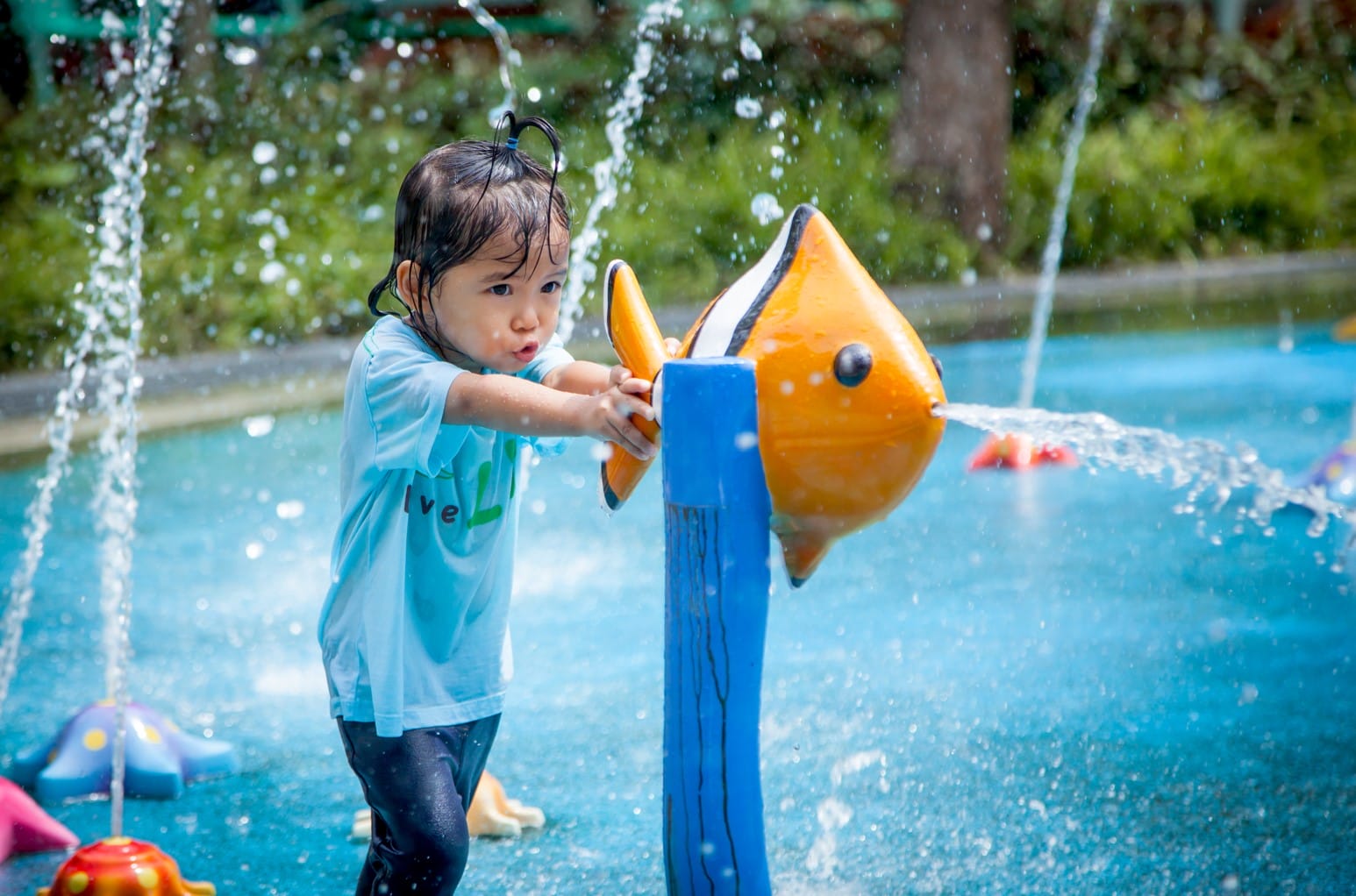 girl playing with water shooting game