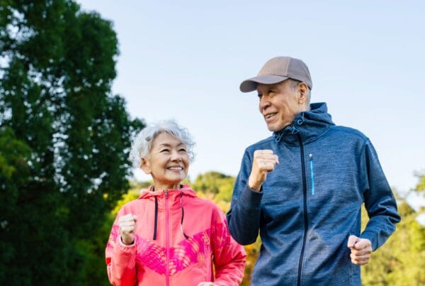 senior couple running in the forest