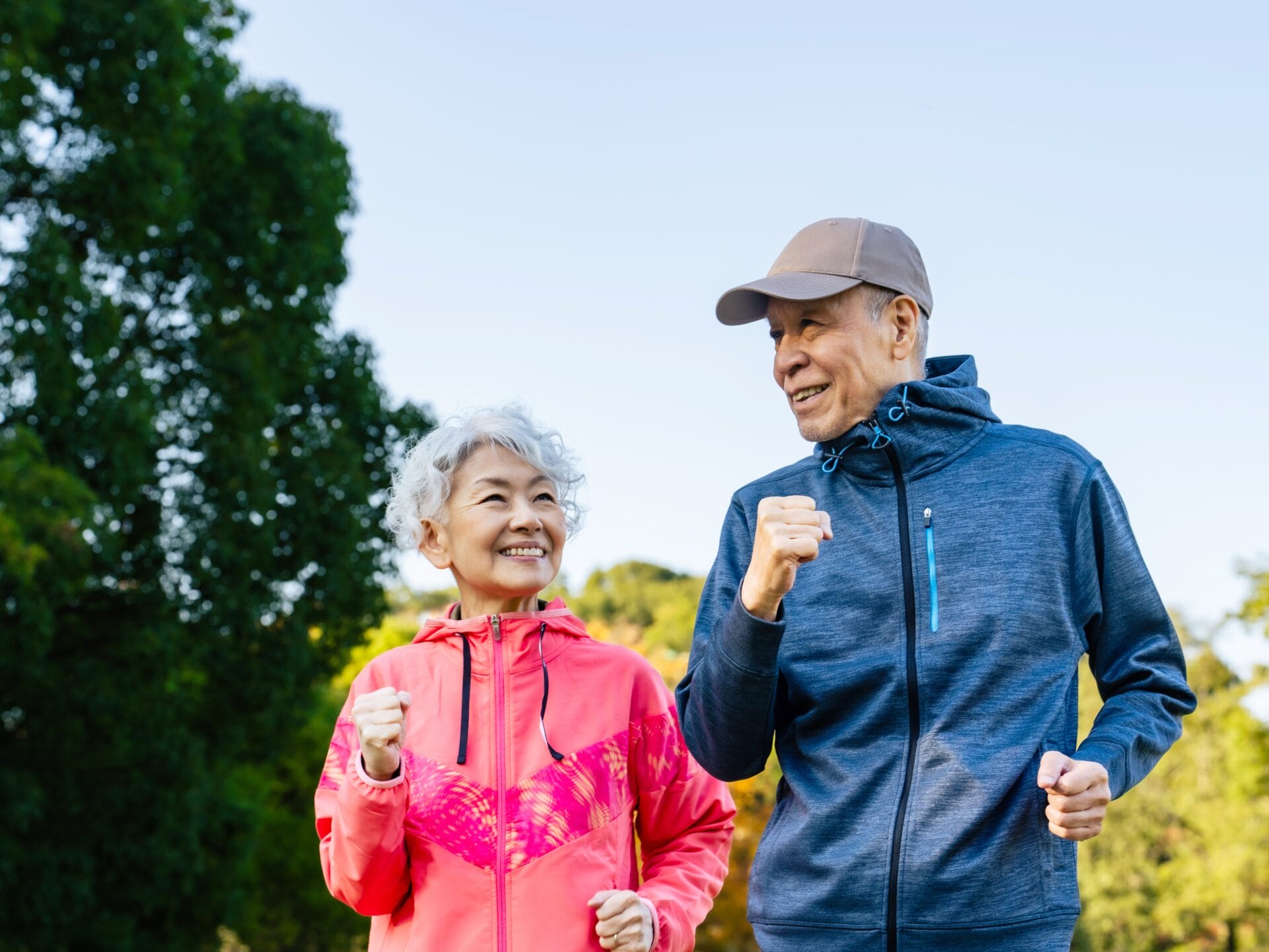 senior couple running in the forest